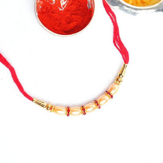 Designer Gold Pearl Rakhi for Brother with Complimentary Roli Chawal