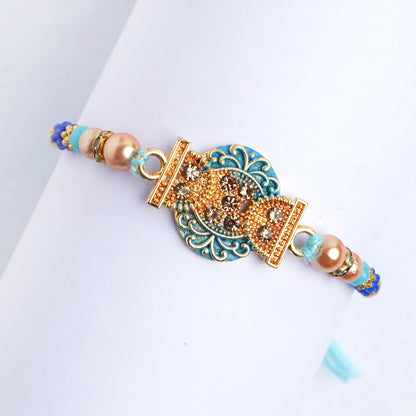 Beautiful Designer Blue Pearl Rakhi for Brother Comes with Complimentary Roli Chawal